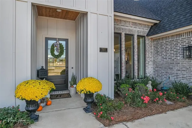 a vase of flowers sitting in front of a glass door
