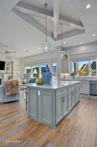 a kitchen with stainless steel appliances granite countertop a sink counter space and wooden floor