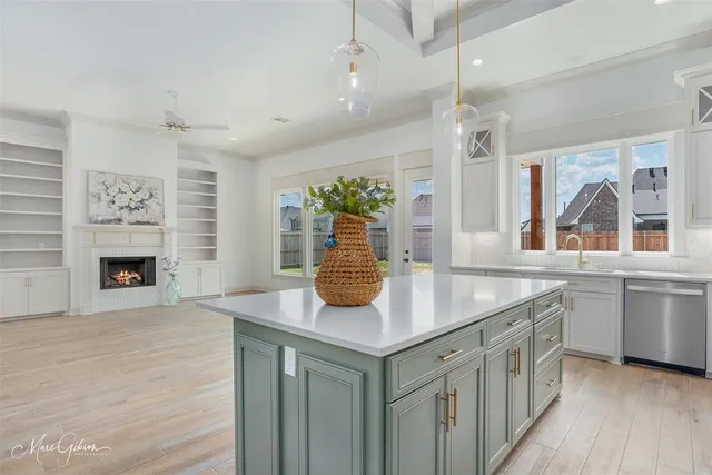 a kitchen with stainless steel appliances granite countertop a sink and a refrigerator