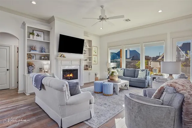 a living room with furniture a flat screen tv and a fireplace