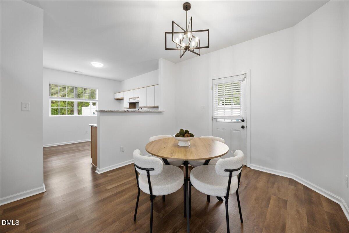 3831 Pin Oak Road Raleigh, NC 27604 - Photo 6 of 24 a view of a dining room with furniture and wooden floor