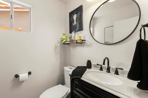a view of a dining room with furniture and a clock