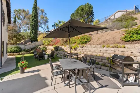 a backyard of a house with table and chairs