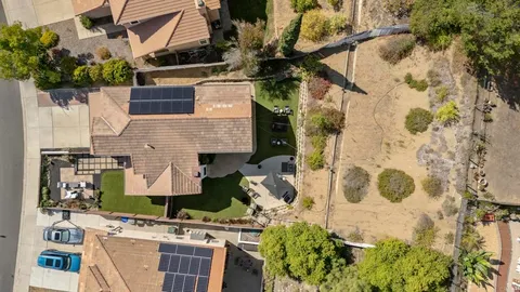 an aerial view of residential building with parking and ocean view