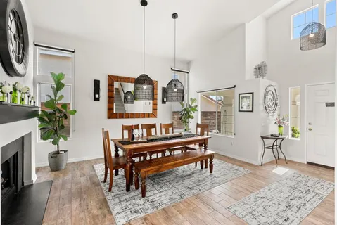 a dining room with furniture window and wooden floor
