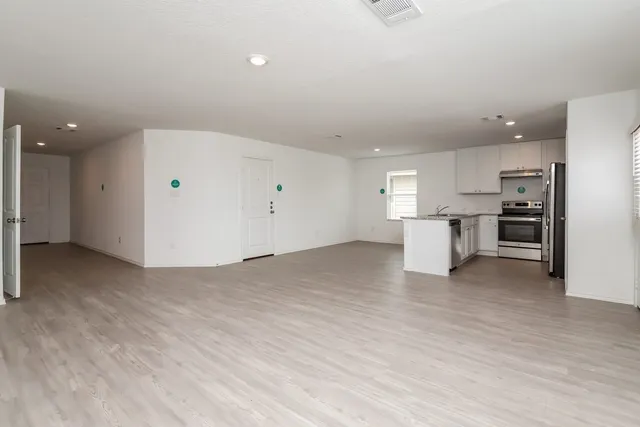 a view of a kitchen with a sink and a refrigerator