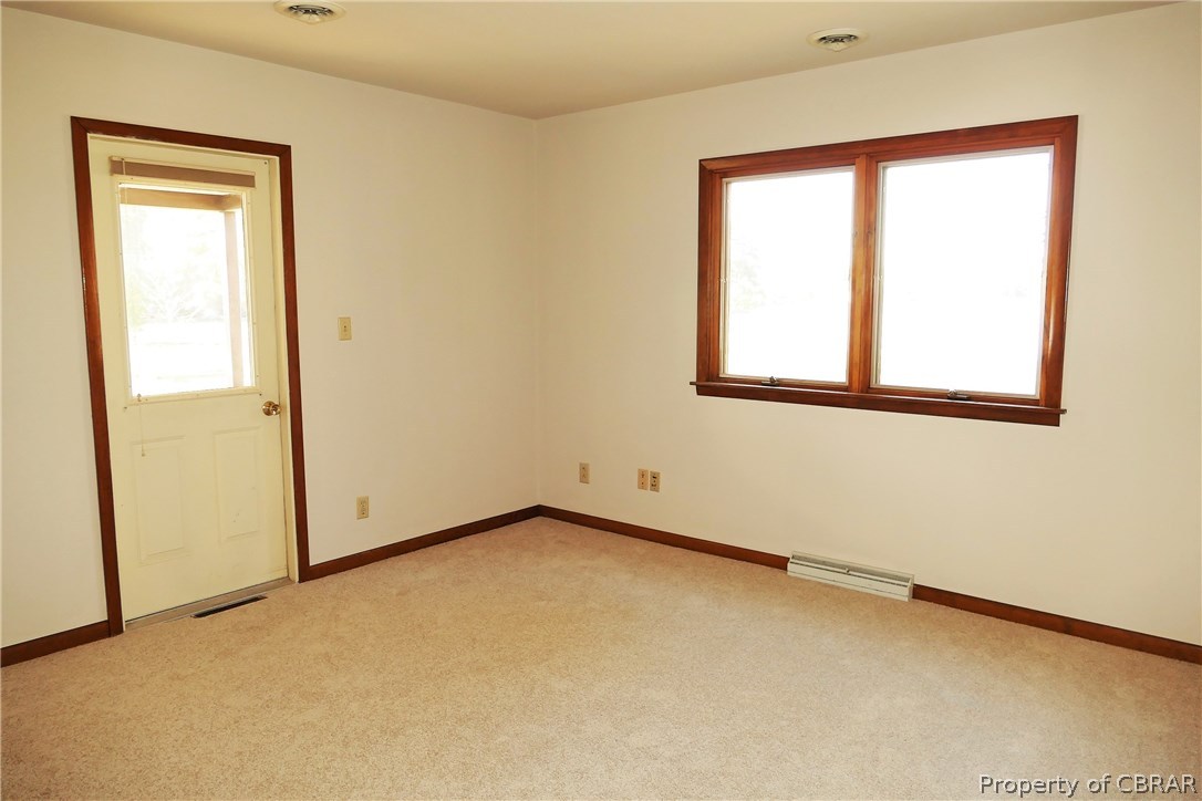 895 Holly Point Road Mathews, VA 23109 - Photo 30 of 47 an empty room with a window
