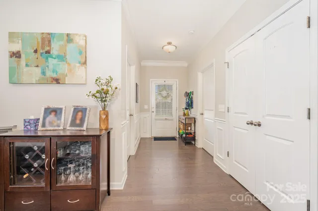 a view of a hallway to a livingroom with furniture