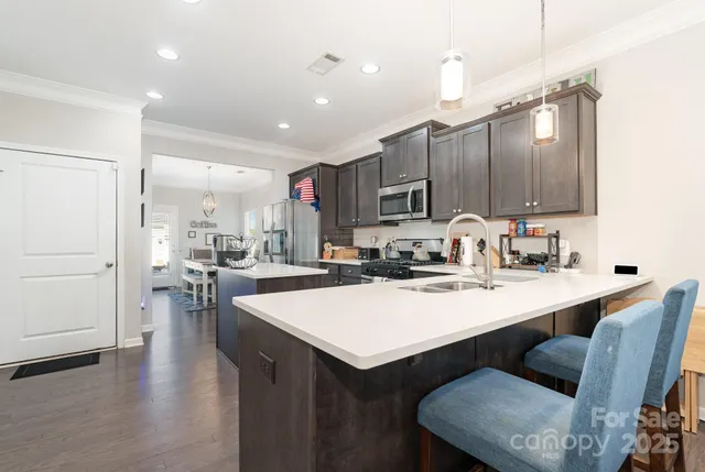a kitchen with sink cabinets and wooden floor