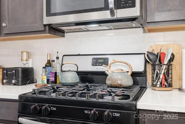 a stove top oven sitting inside of a kitchen