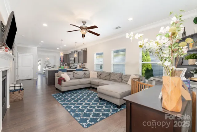 a living room with furniture and a chandelier