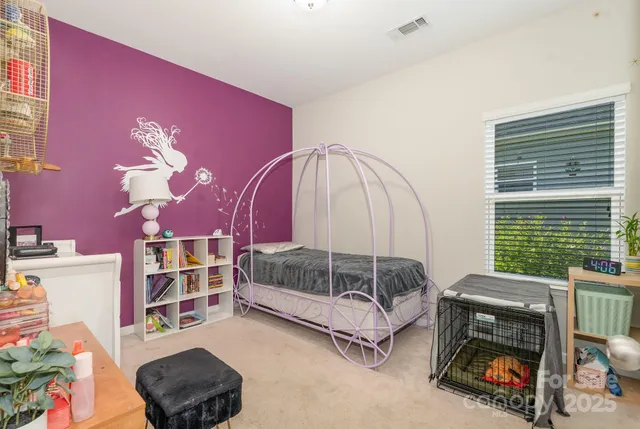 a bedroom with furniture and a window