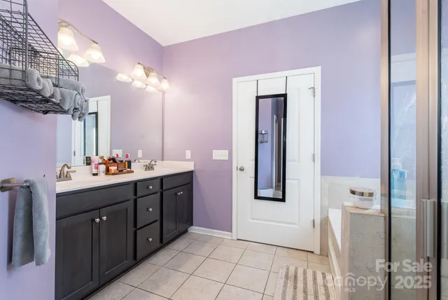 a bathroom with a double vanity sink mirror and toilet