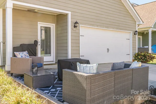 a living room with couches and a potted plant