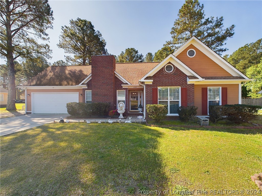 6948 Rockfish Road Raeford, NC 28376 - Photo 1 of 39 a front view of a house with a yard and garage