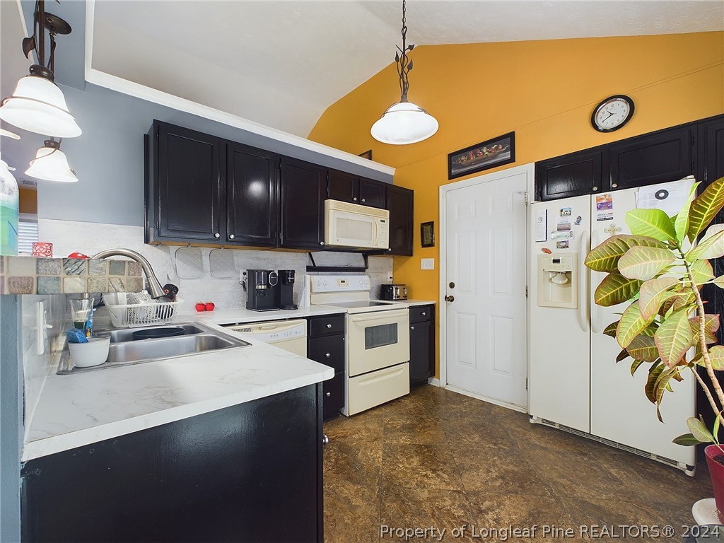 6948 Rockfish Road Raeford, NC 28376 - Photo 11 of 39 a kitchen with stainless steel appliances a stove a refrigerator and a sink