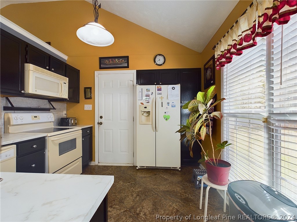 6948 Rockfish Road Raeford, NC 28376 - Photo 12 of 39 a kitchen that has a lot of cabinets and appliances