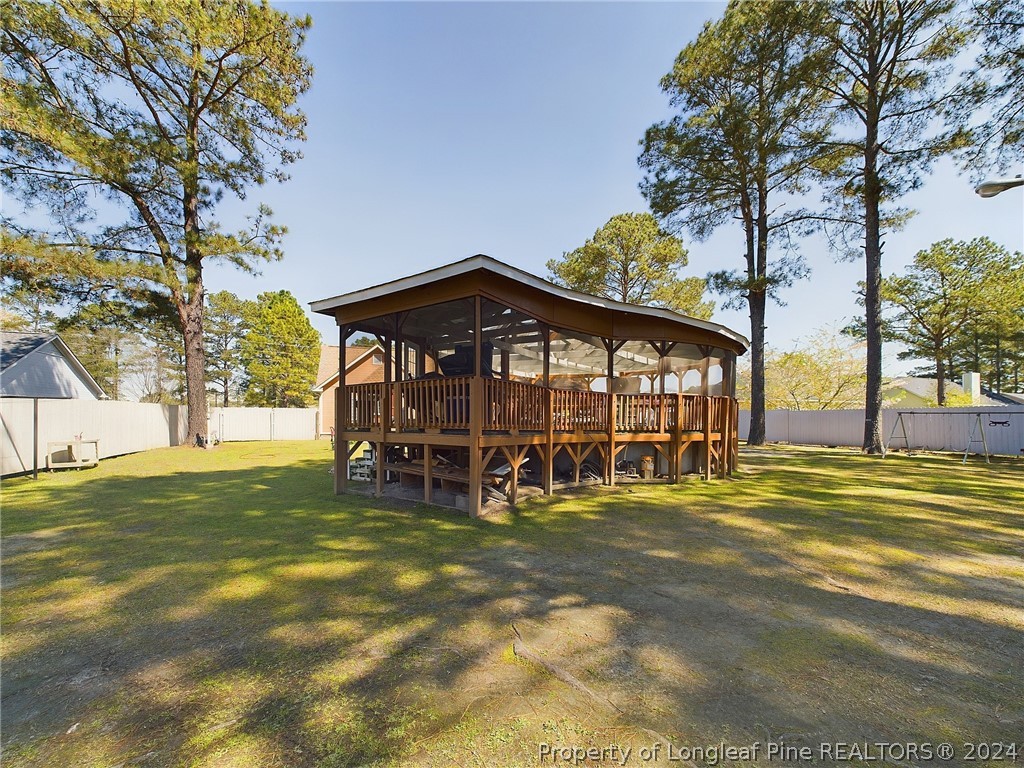 6948 Rockfish Road Raeford, NC 28376 - Photo 29 of 39 a view of a house with a yard table and chairs
