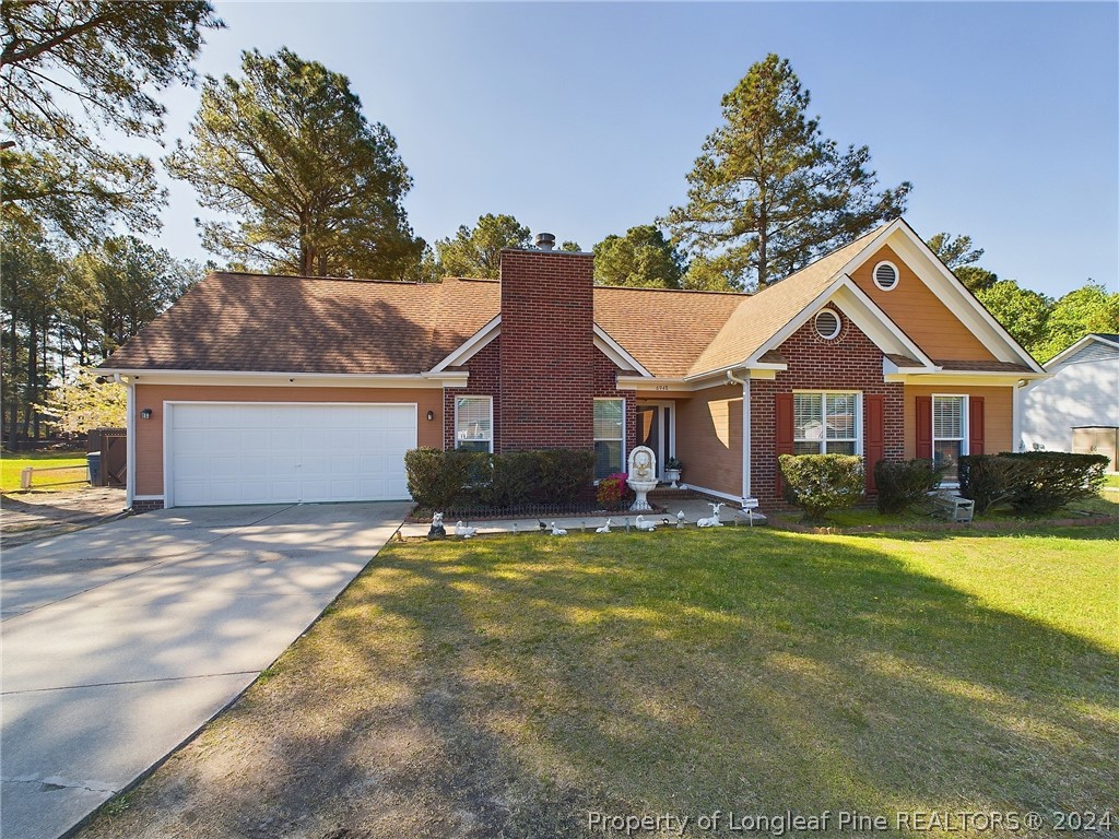 6948 Rockfish Road Raeford, NC 28376 - Photo 3 of 39 a view of a yard in front of a house with large tree