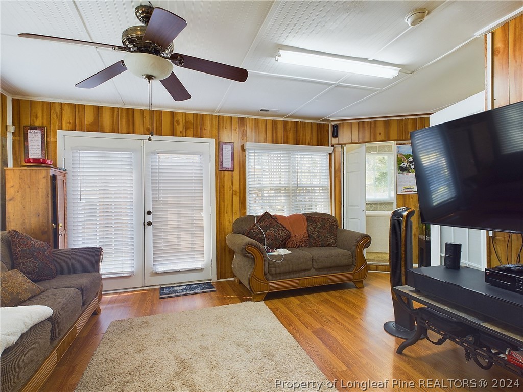 6948 Rockfish Road Raeford, NC 28376 - Photo 33 of 39 a living room with furniture and a flat screen tv