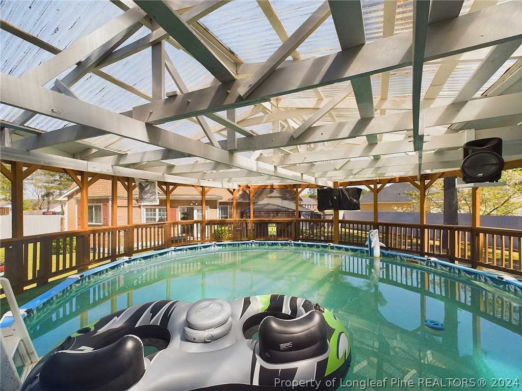 6948 Rockfish Road Raeford, NC 28376 - Photo 35 of 39 a view of a swimming pool with a patio and a yard
