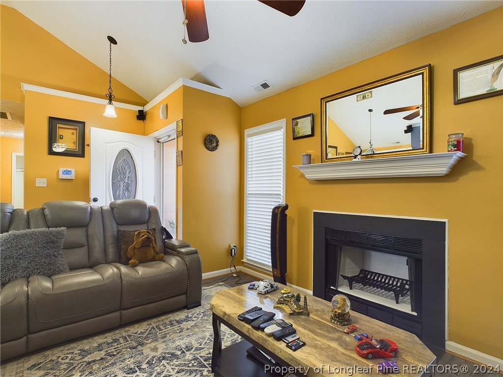 6948 Rockfish Road Raeford, NC 28376 - Photo 5 of 39 a living room with furniture and a fireplace
