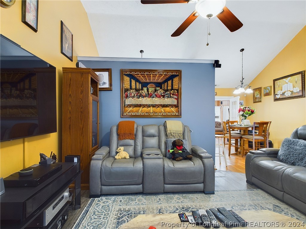 6948 Rockfish Road Raeford, NC 28376 - Photo 6 of 39 a living room with furniture and a flat screen tv
