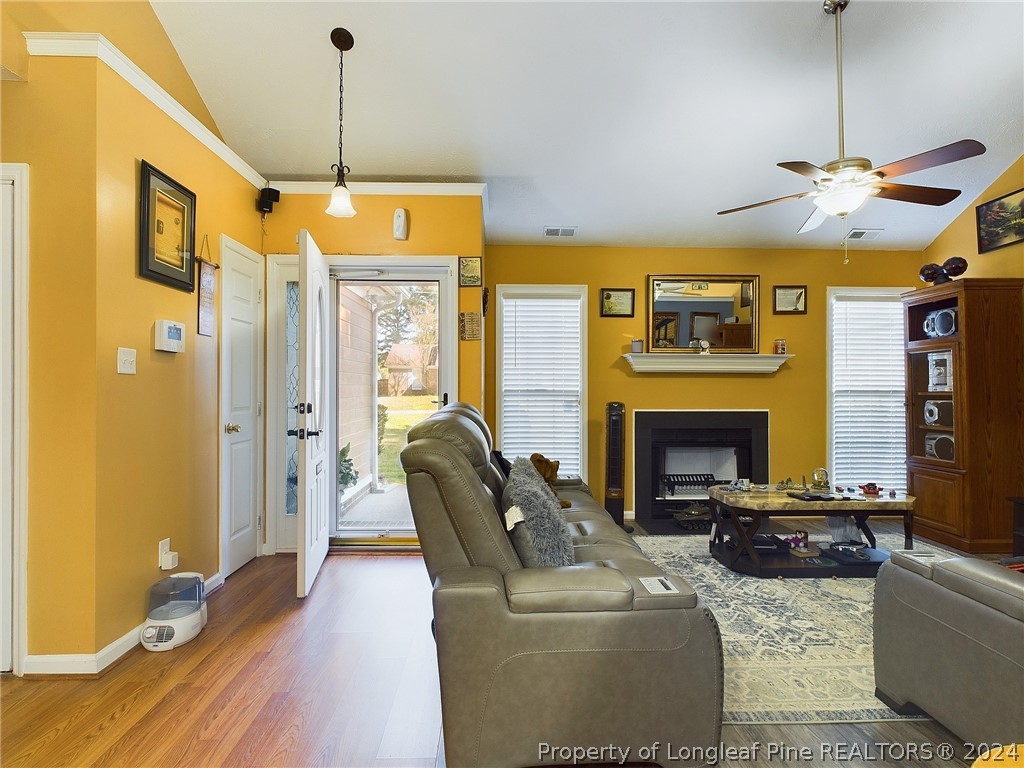 6948 Rockfish Road Raeford, NC 28376 - Photo 7 of 39 a living room with furniture flat screen tv and a fireplace