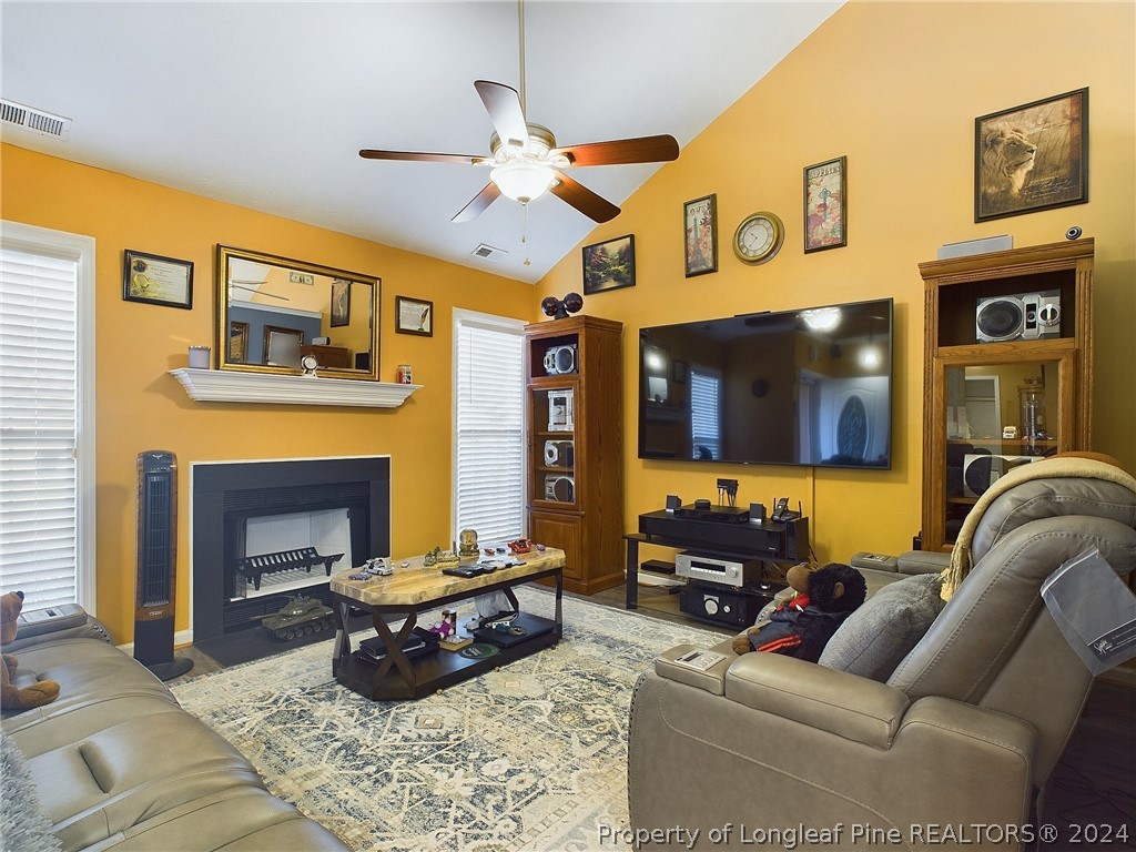 6948 Rockfish Road Raeford, NC 28376 - Photo 8 of 39 a living room with furniture and a fireplace