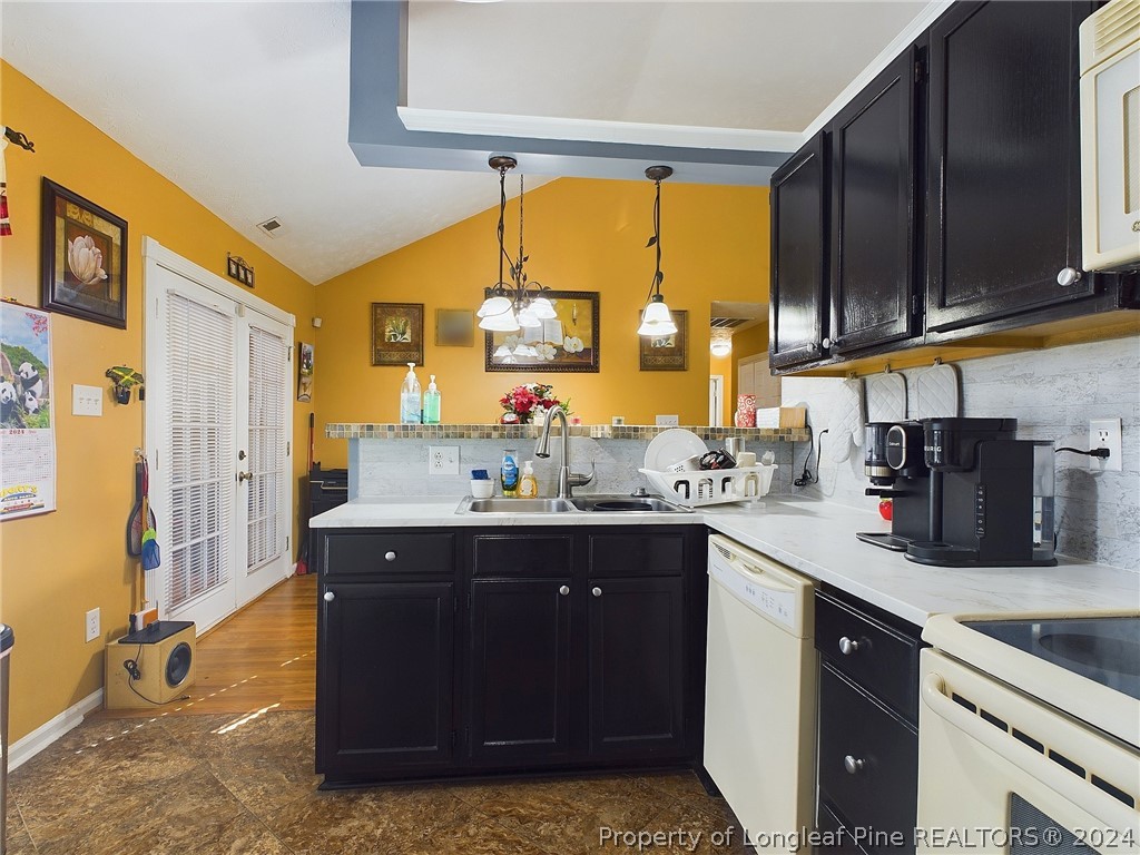 6948 Rockfish Road Raeford, NC 28376 - Photo 9 of 39 a kitchen with stainless steel appliances granite countertop a sink and a cabinets