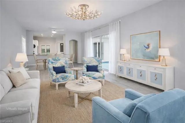 a view of a room with lots of furniture and a chandelier