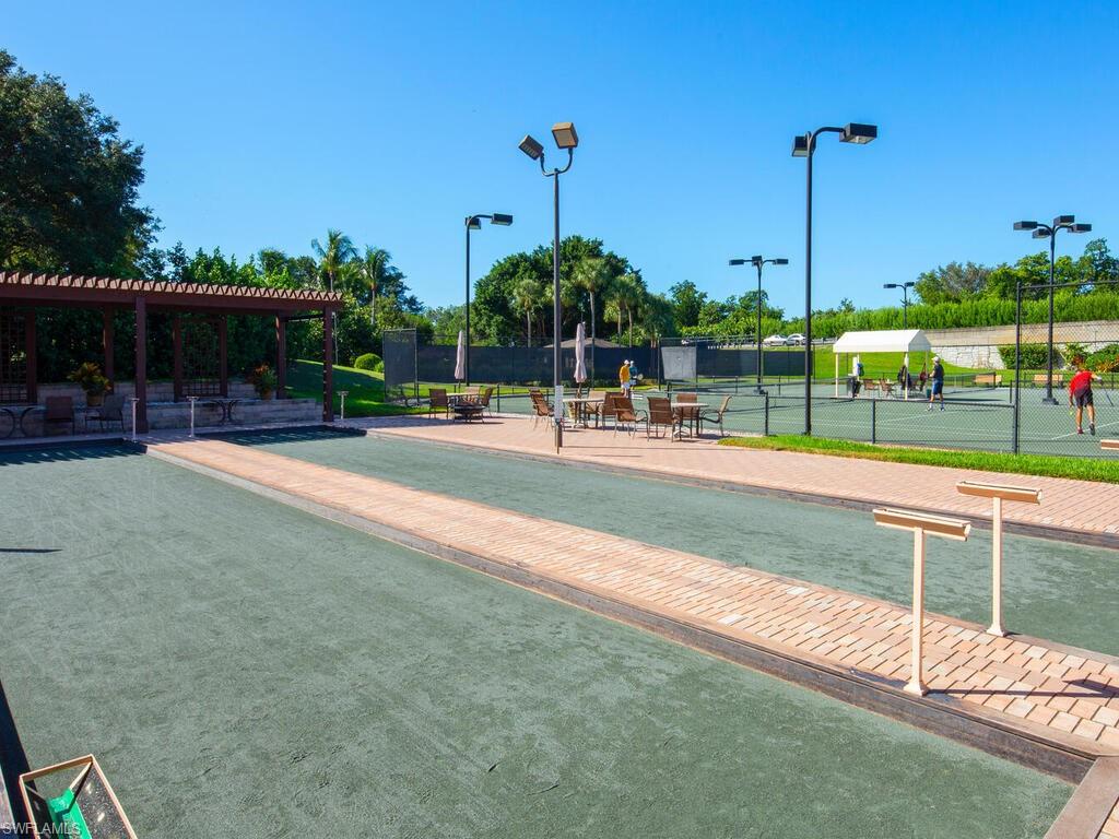 1770 Marsh Run Naples, FL 34109 - Photo 32 of 33 a view of a swimming pool with a bench and lawn chairs