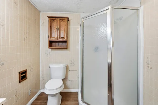 a bathroom with a toilet and a shower curtain