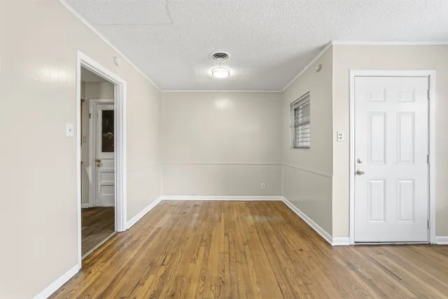 a view of a room with wooden floor and brick walls