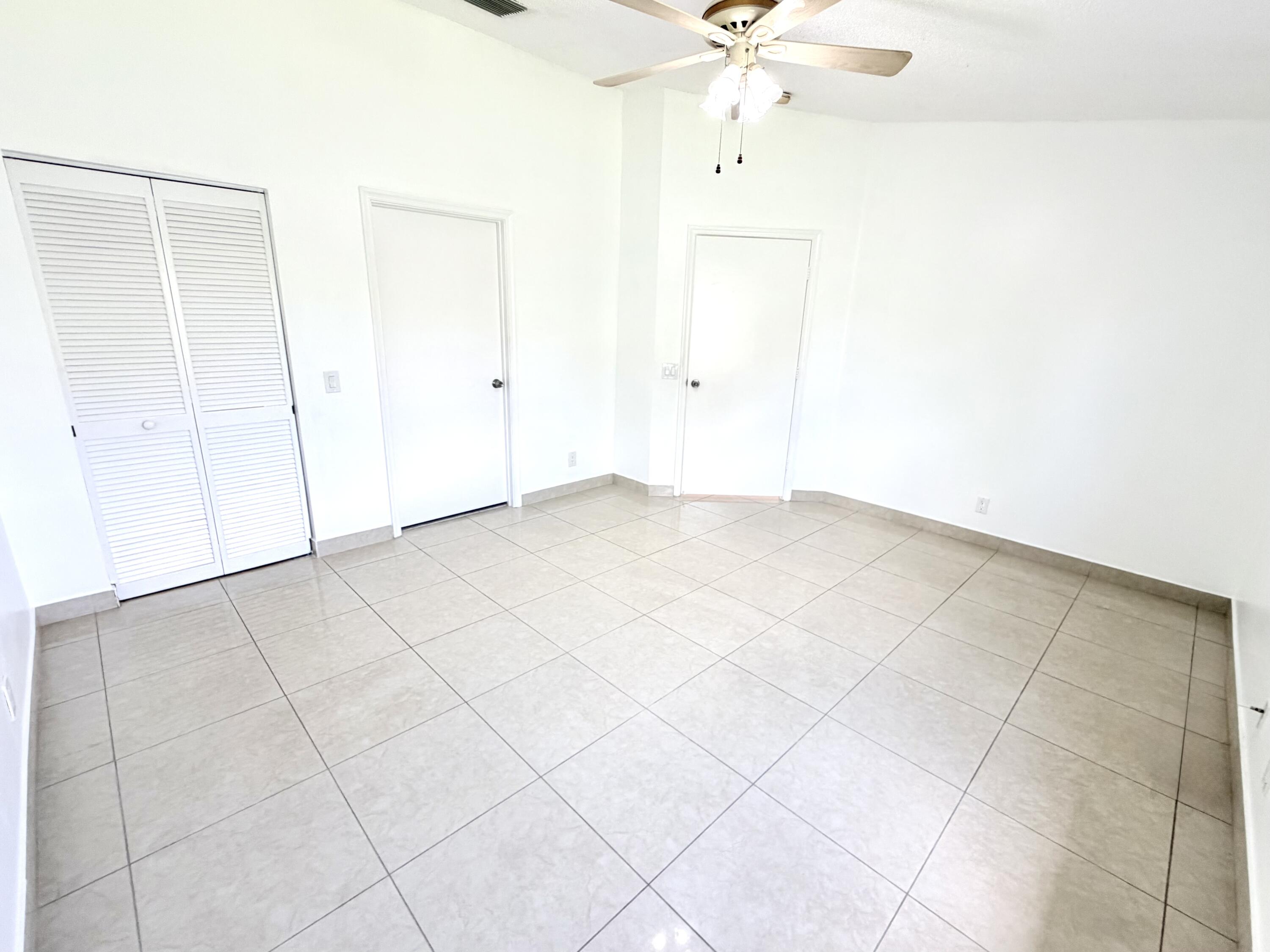 11697 Southwest 19th Street Miramar, FL 33025 - Photo 13 of 48 an empty room with fan and entryway