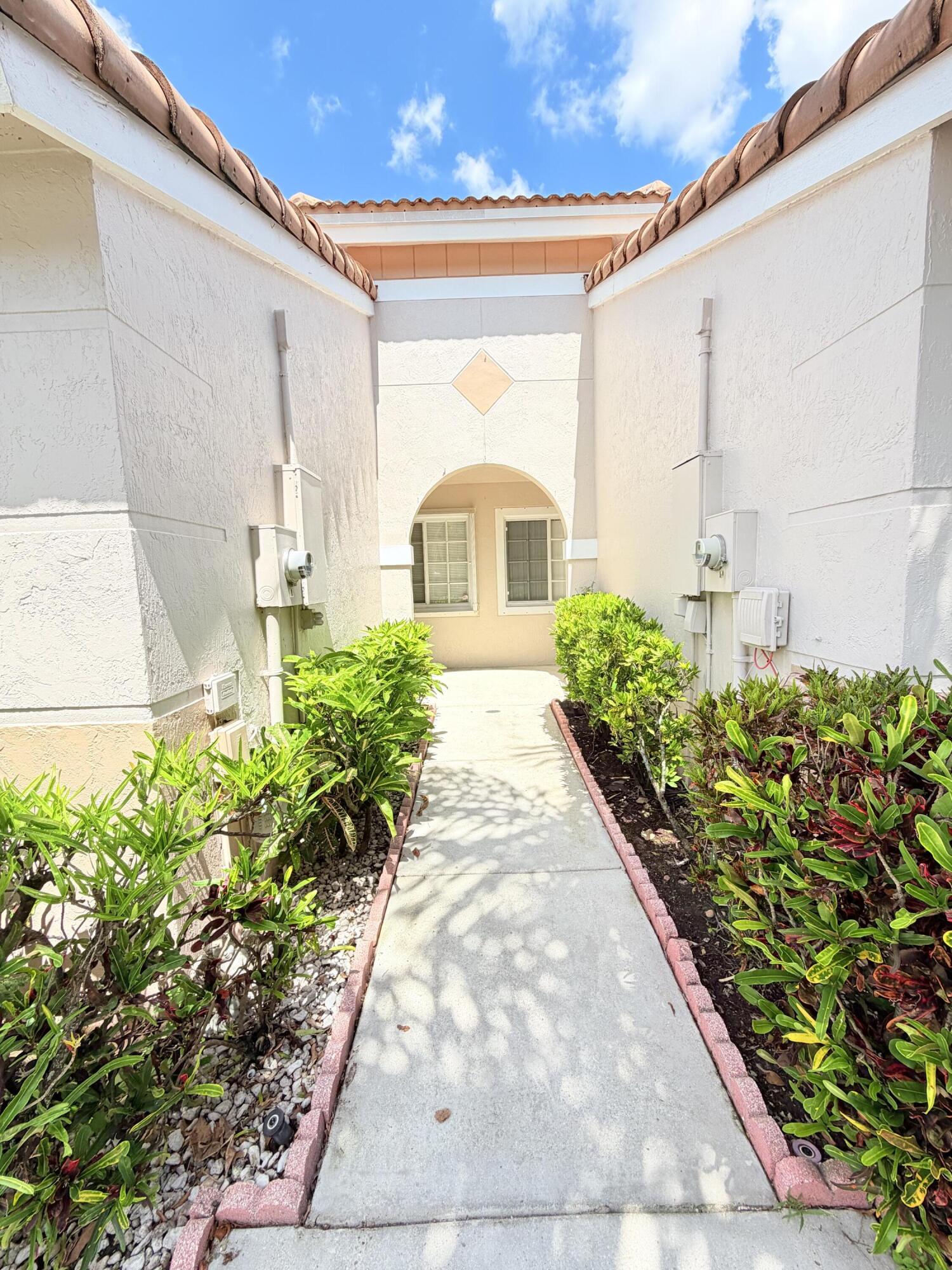 11697 Southwest 19th Street Miramar, FL 33025 - Photo 2 of 48 a view of a house with a flower garden