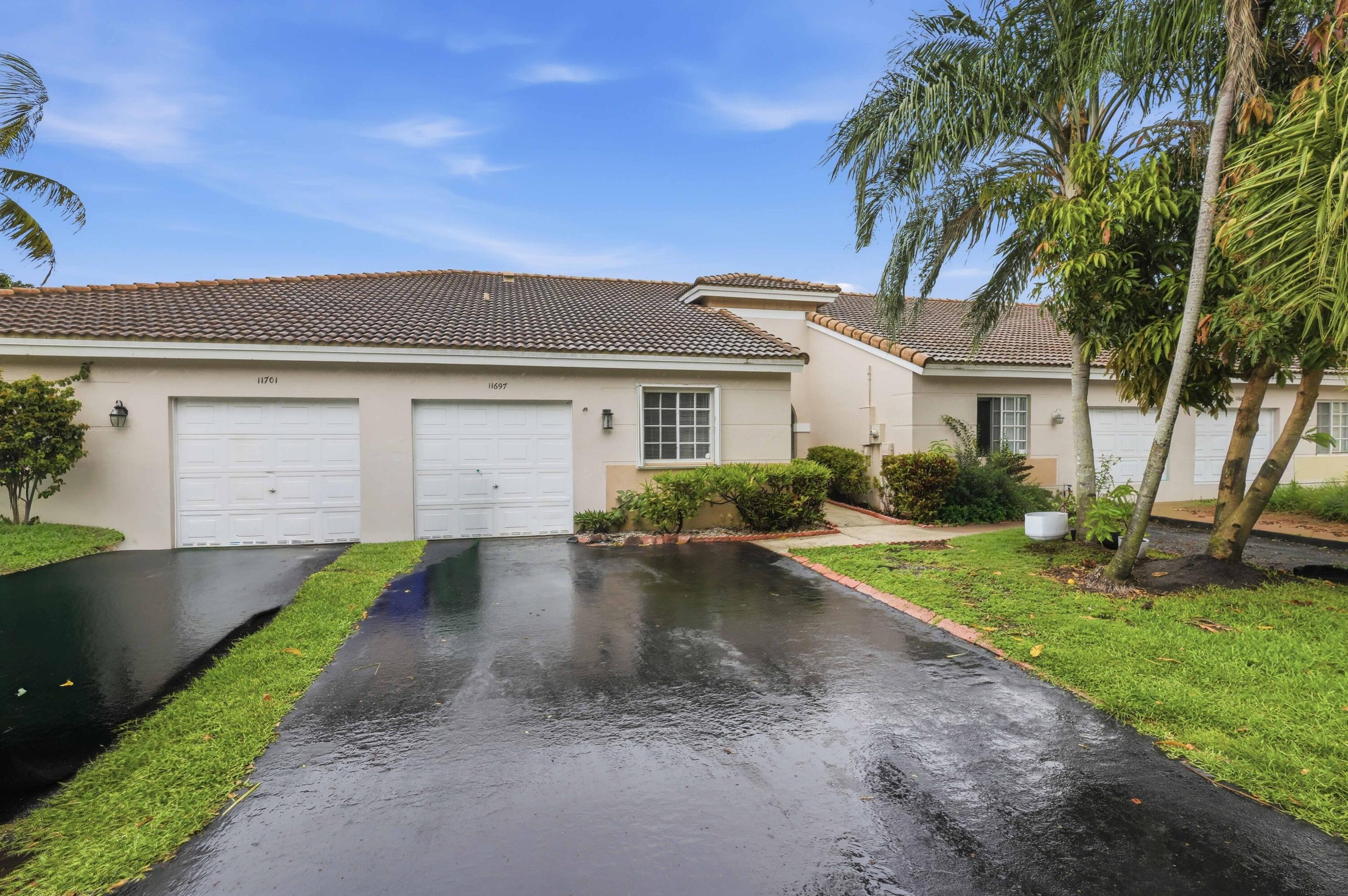 11697 Southwest 19th Street Miramar, FL 33025 - Photo 23 of 48 a front view of a house with a yard and garage