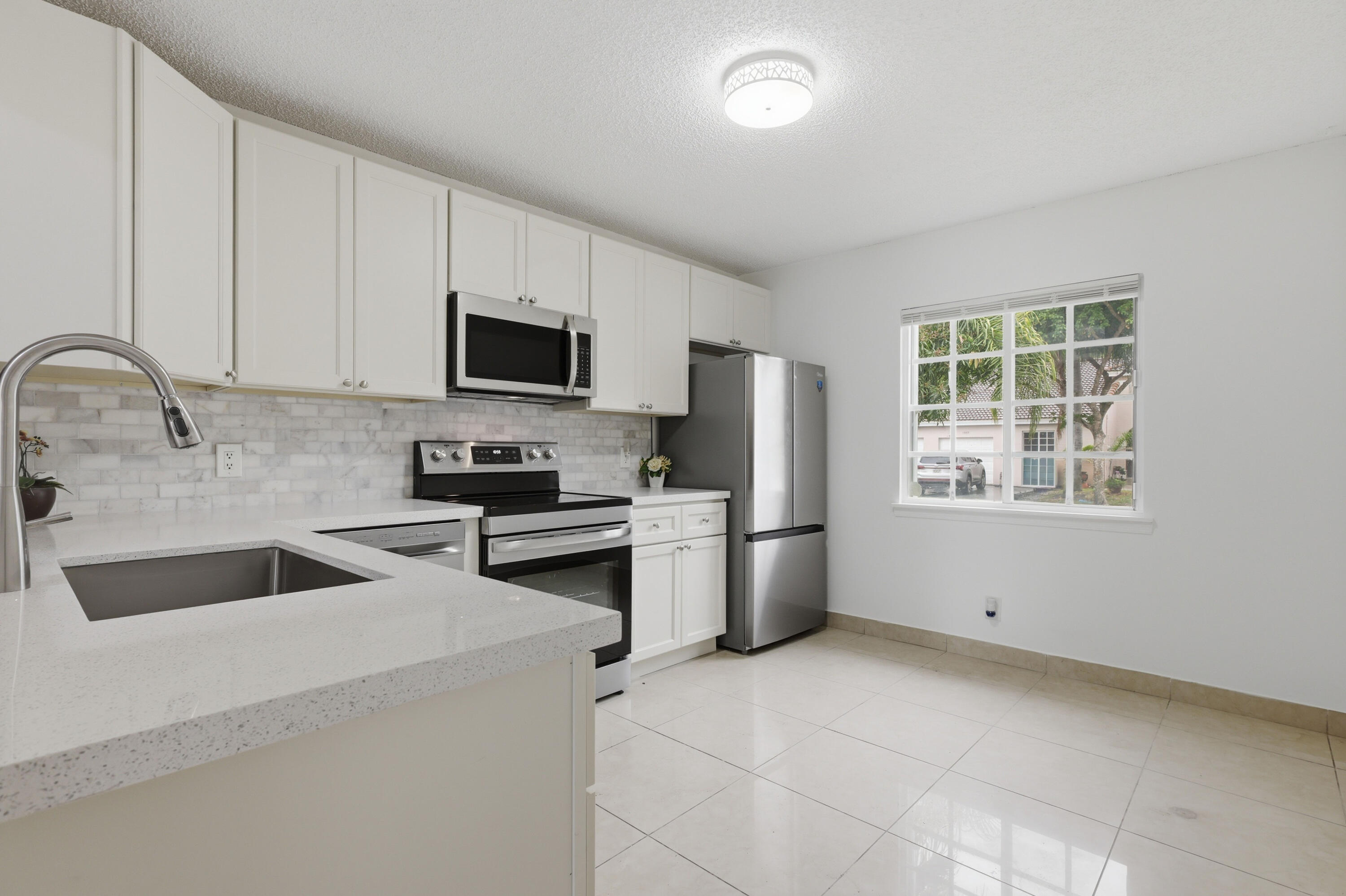 11697 Southwest 19th Street Miramar, FL 33025 - Photo 26 of 48 a kitchen with a refrigerator and a sink