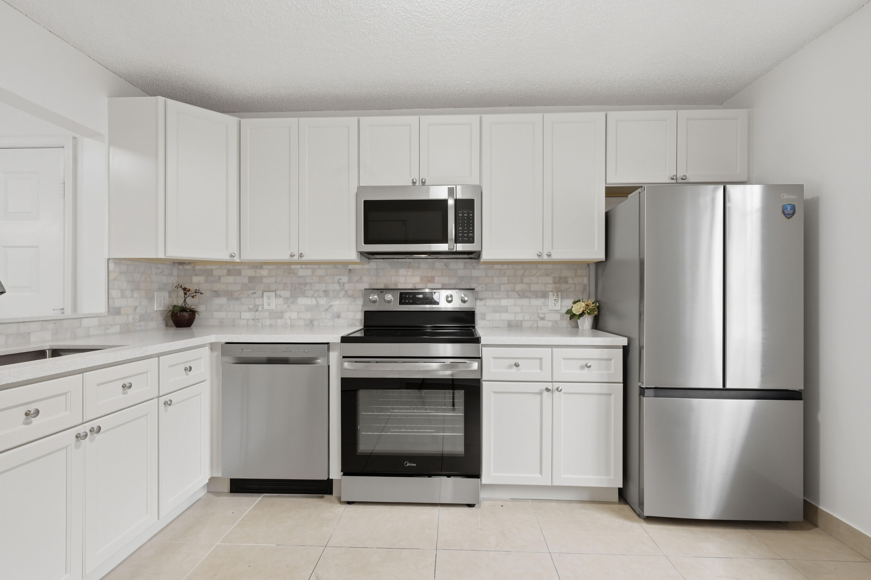11697 Southwest 19th Street Miramar, FL 33025 - Photo 28 of 48 a kitchen with cabinets stainless steel appliances and a sink