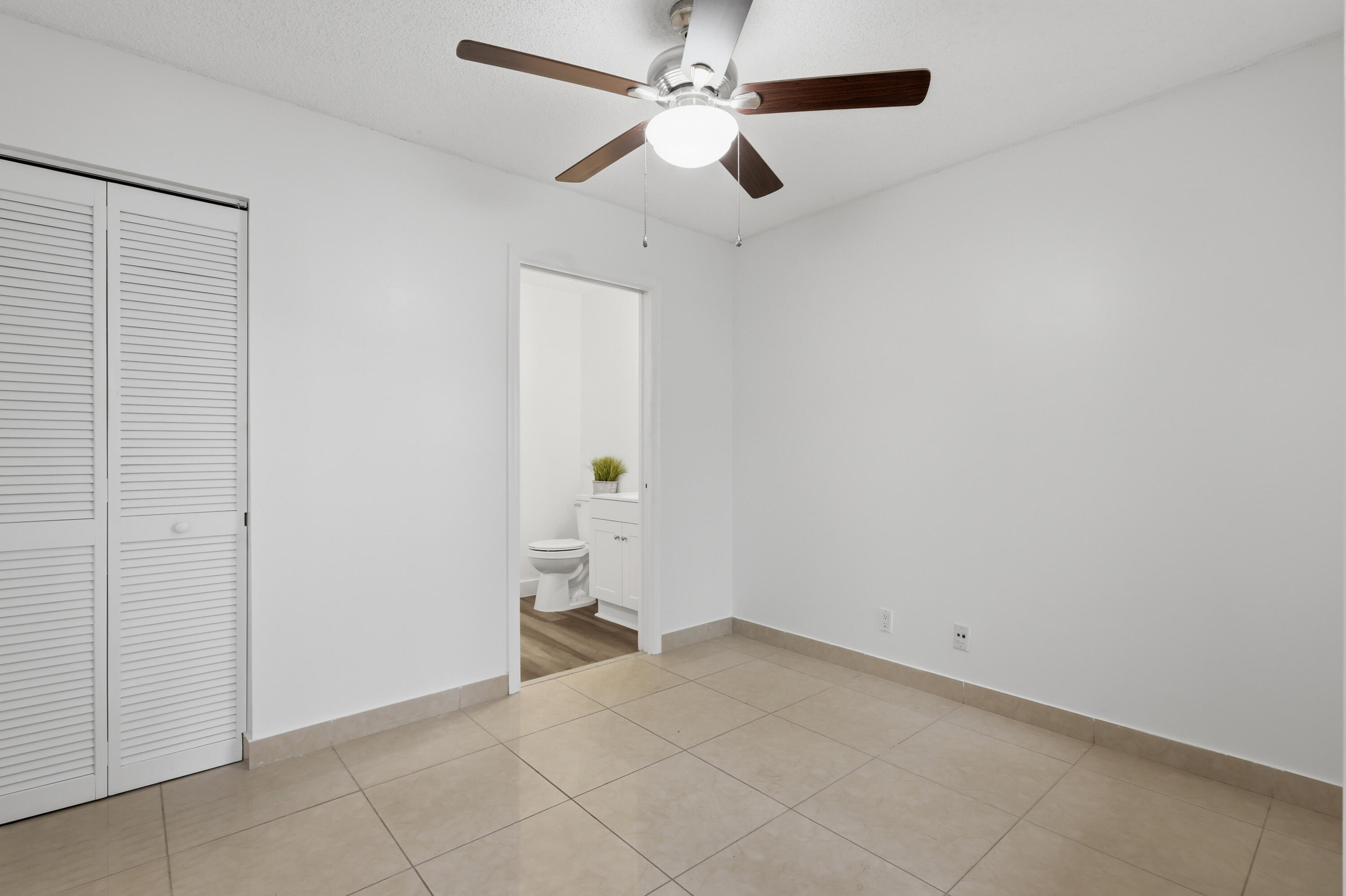 11697 Southwest 19th Street Miramar, FL 33025 - Photo 30 of 48 an empty room with a ceiling fan and carpet
