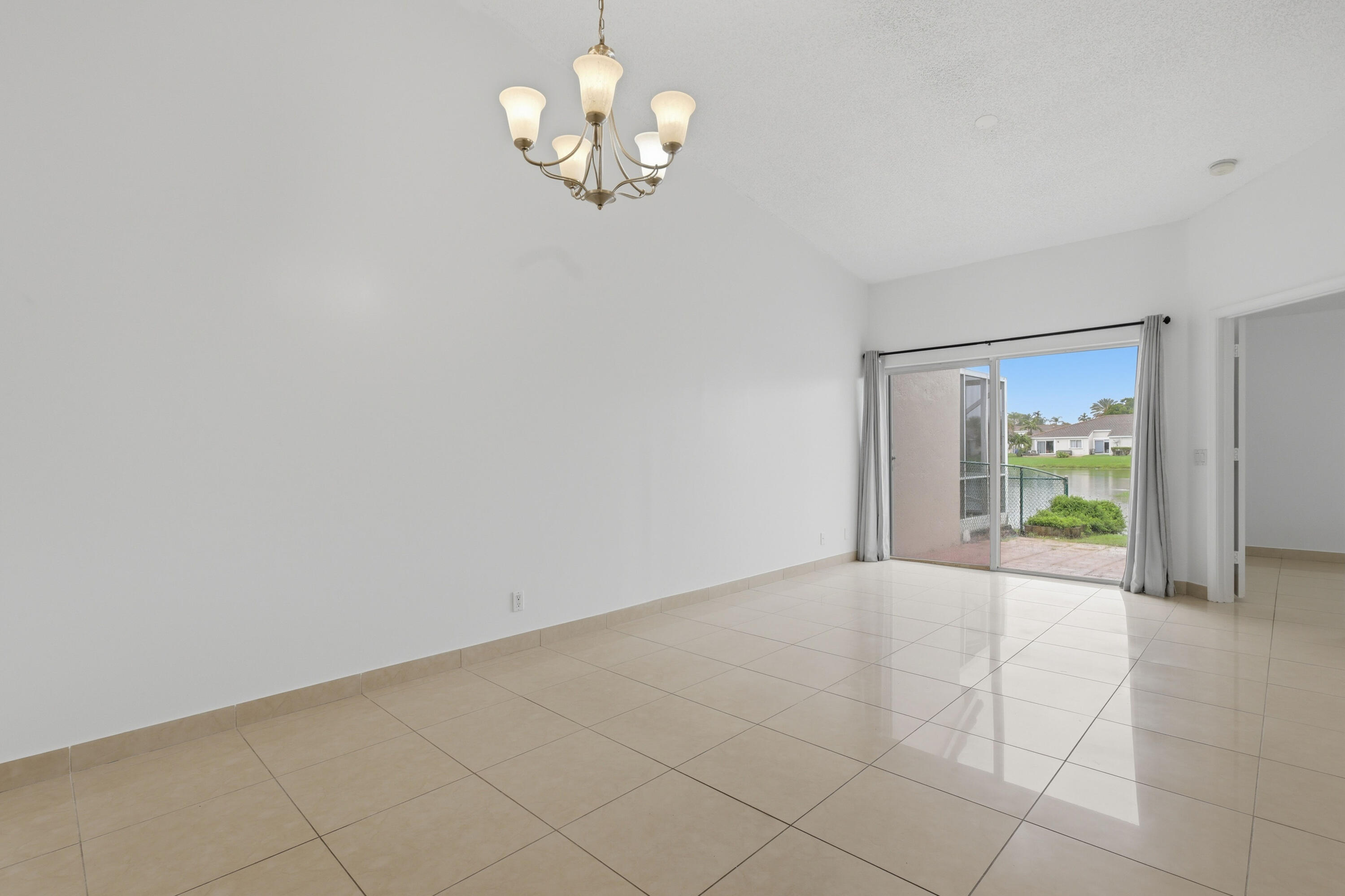 11697 Southwest 19th Street Miramar, FL 33025 - Photo 37 of 48 a view of an empty room with a chandelier fan