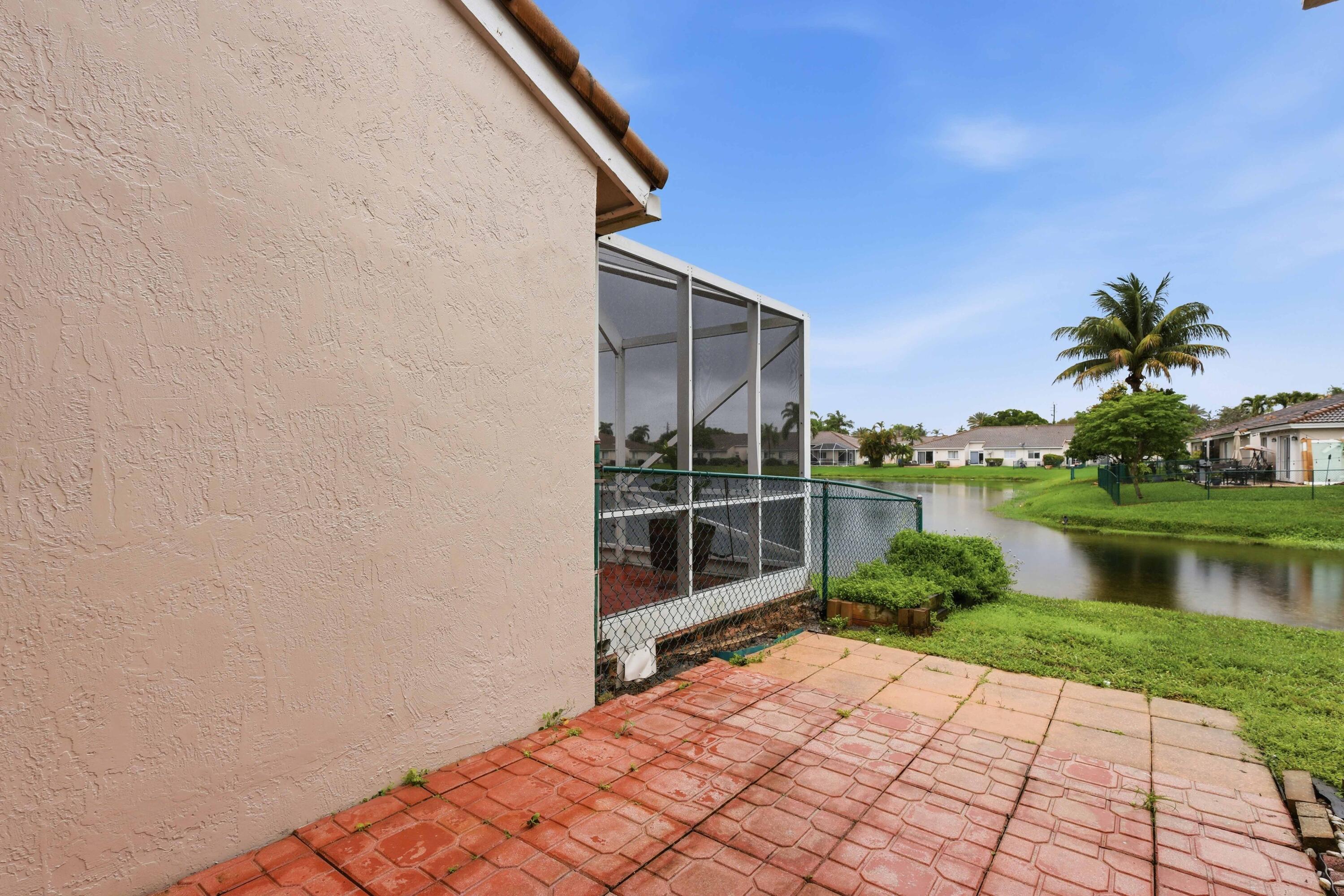 11697 Southwest 19th Street Miramar, FL 33025 - Photo 41 of 48 a backyard of a house with a lake view