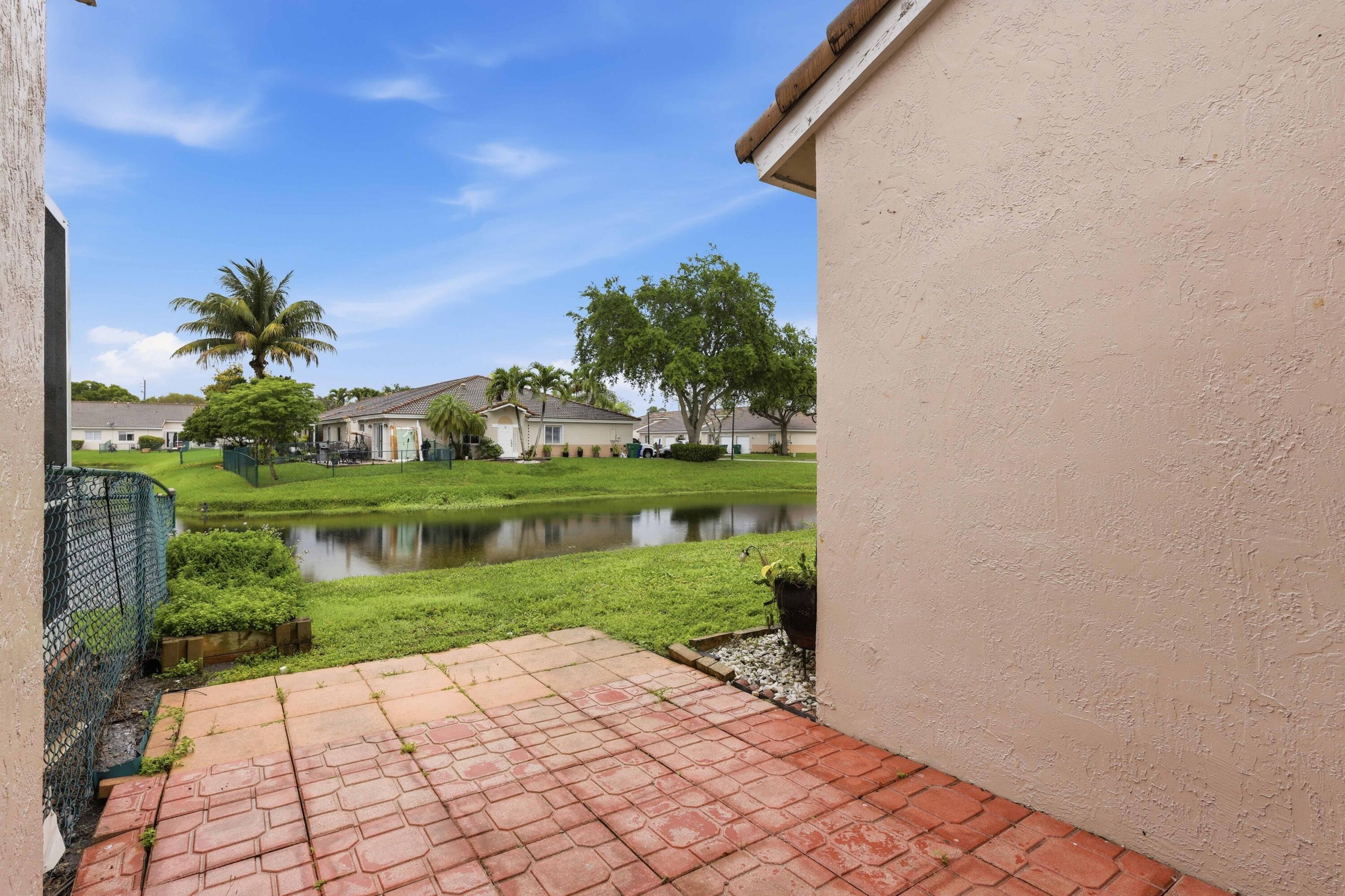 11697 Southwest 19th Street Miramar, FL 33025 - Photo 42 of 48 a backyard of a house with lots of green space and lake view
