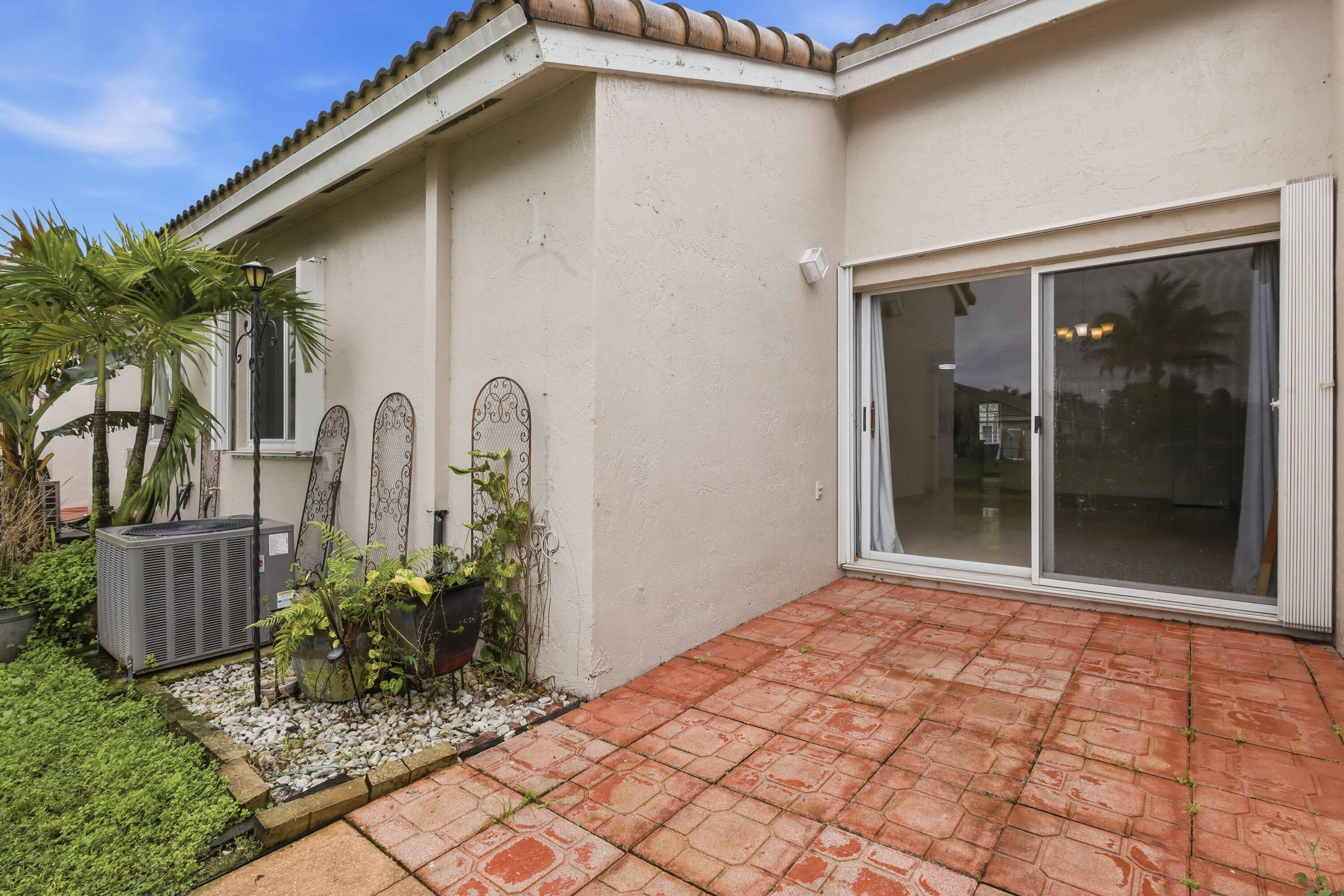 11697 Southwest 19th Street Miramar, FL 33025 - Photo 43 of 48 a front view of a house with garden