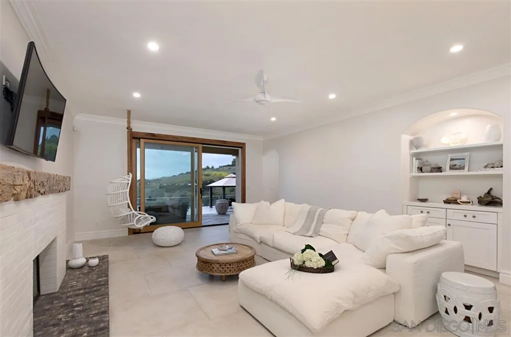 1836 Hawk View Drive Encinitas, CA 92024 - Photo 12 of 25 a living room with furniture and a flat screen tv