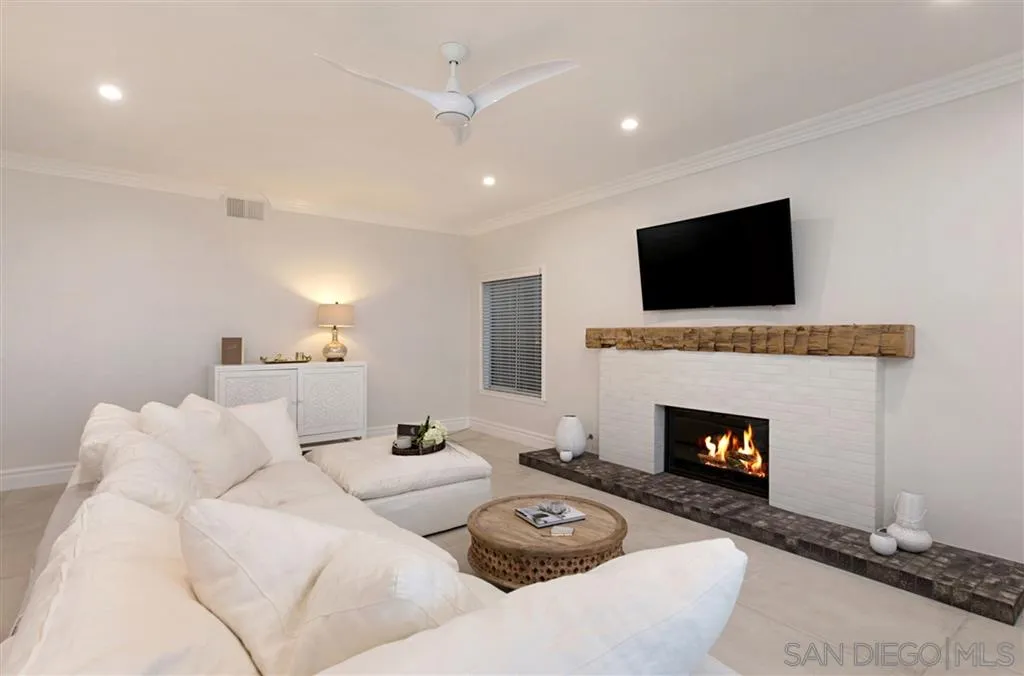 1836 Hawk View Drive Encinitas, CA 92024 - Photo 14 of 25 a living room with furniture a fireplace and a flat screen tv
