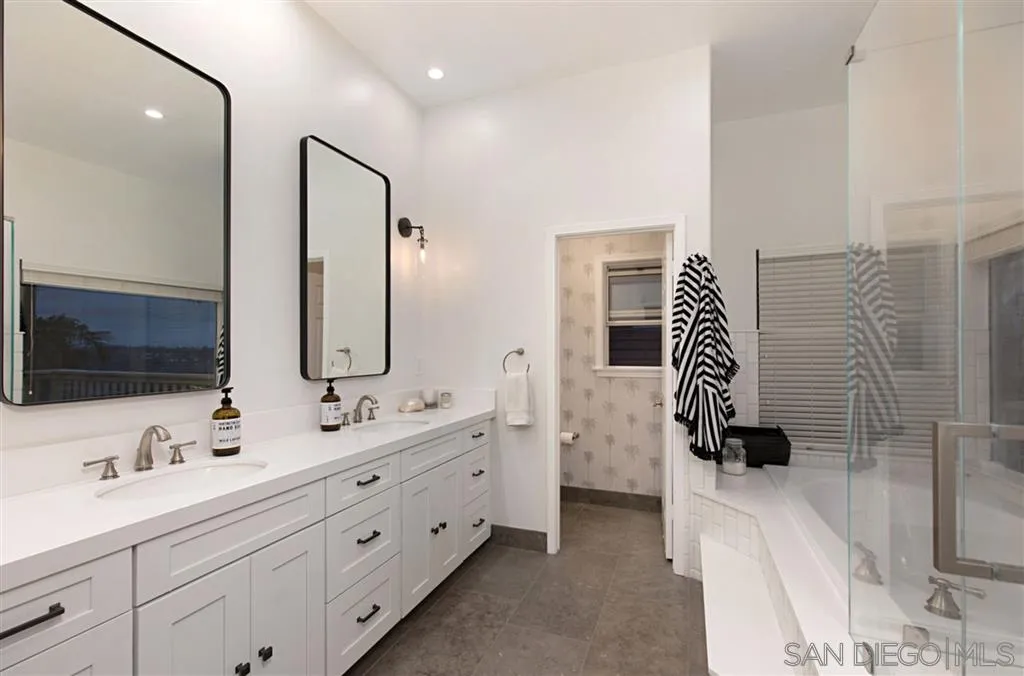 1836 Hawk View Drive Encinitas, CA 92024 - Photo 18 of 25 a bathroom with a double vanity sink and mirror
