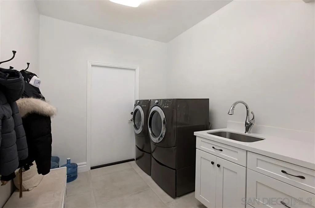 1836 Hawk View Drive Encinitas, CA 92024 - Photo 22 of 25 a bathroom with a granite countertop sink and a mirror