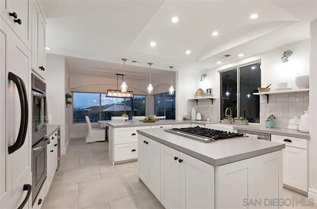1836 Hawk View Drive Encinitas, CA 92024 - Photo 7 of 25 a kitchen that has a lot of cabinets a sink and appliances