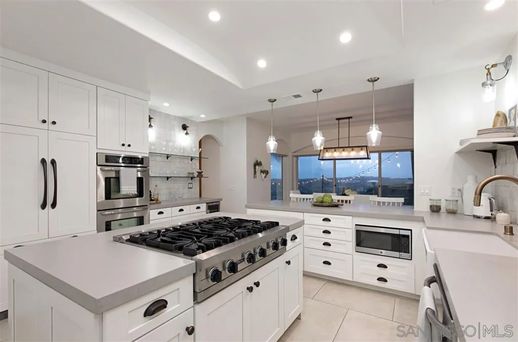 1836 Hawk View Drive Encinitas, CA 92024 - Photo 8 of 25 a kitchen with white cabinets and stainless steel appliances
